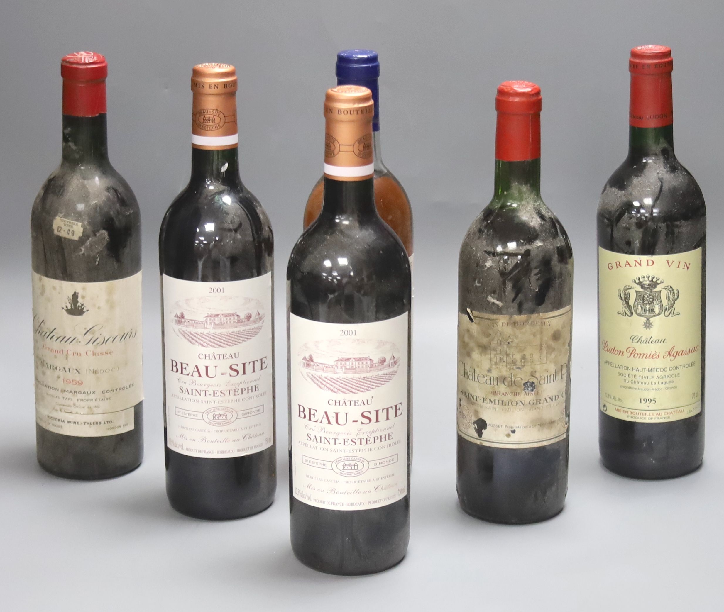 Five red Bordeaux wines including two Chateau Beau Site, Saint Estephe, 2001, one Chateau de Saint Puy, 1982, one Ludon Pomies Agassac, 1995, one Giscours, 1959 and one Les Saintes, Monbazillac, 1989.